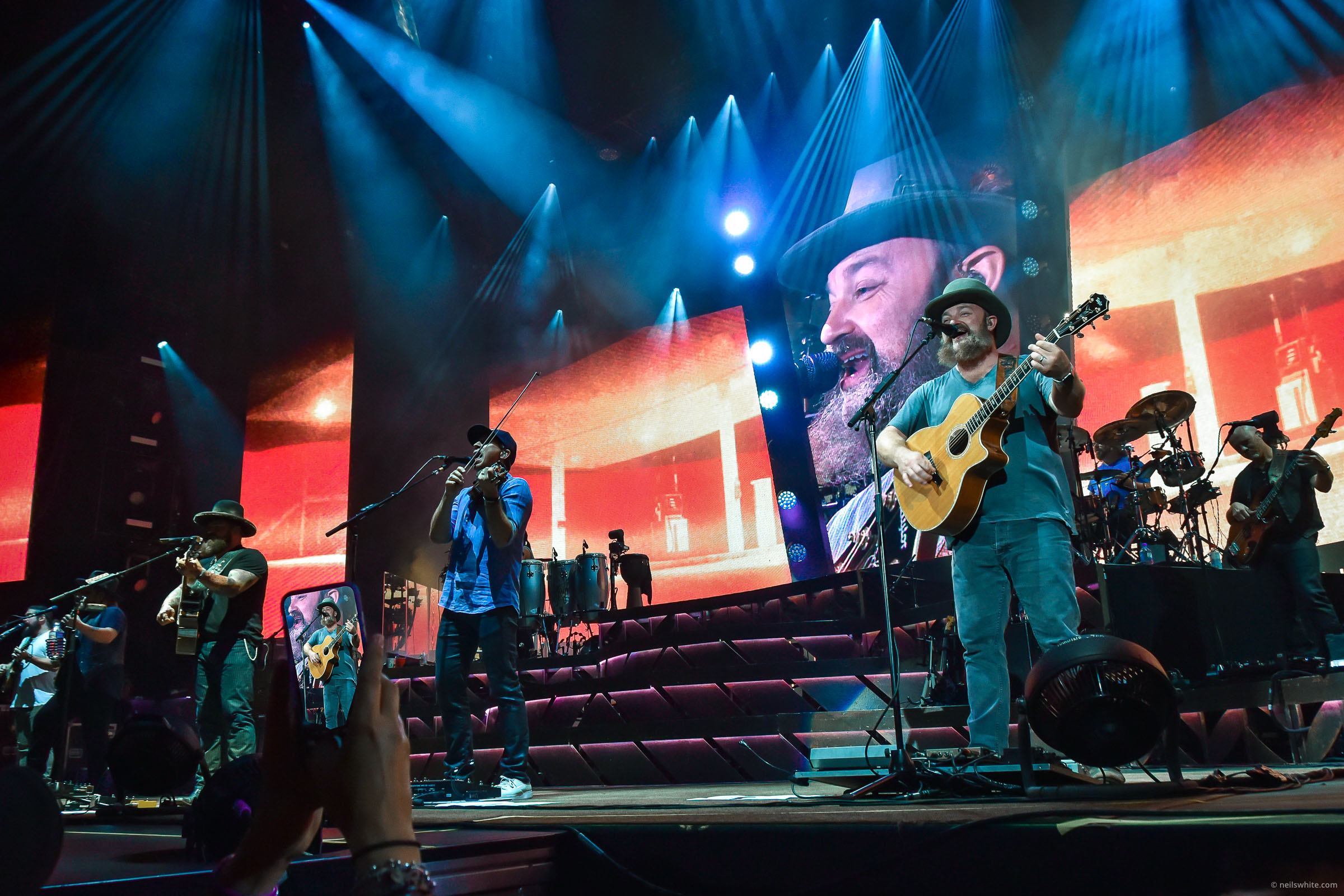John Driskell Hopkins singing and playing guiter at the Zac Brown Band